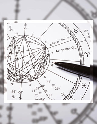 Astrological chart featuring zodiac signs, angles, and celestial lines. A pen highlights specific sections, indicating chart analysis or notation.