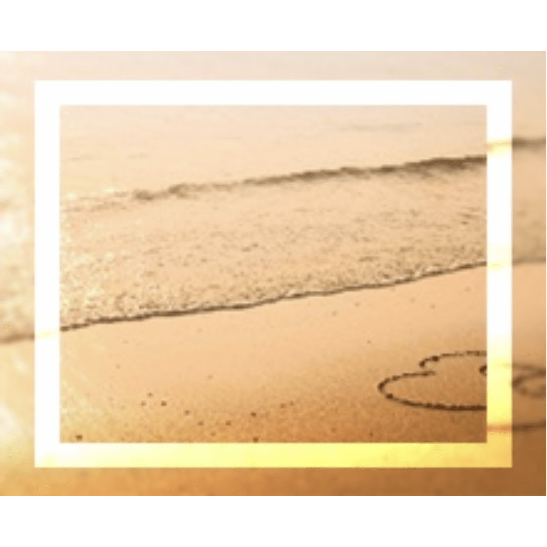 A sandy beach with gentle waves and a heart drawn in the sand, evoking romance and tranquility. Ideal for a love or travel theme.